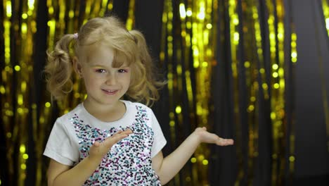 child dancing, enjoying music, moving in slow rhythm dance. girl 4-5 years old in shiny t-shirt