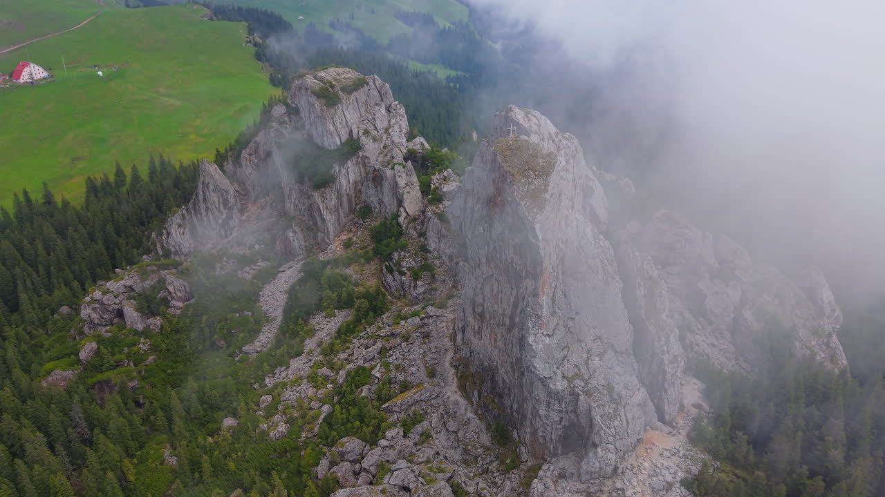 Clouds enveloping Pietrele Doamnei, a rock formation in Rarau Mountains, part of the Carpathians in Romania