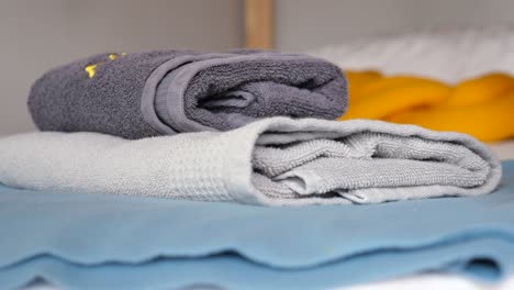 Close-up-of-stack-of-shower-towel-on-table,