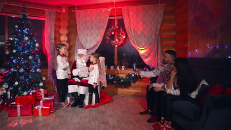 attractive parents and childs enjoying christmas holidays. christmas whole family celebrating.
