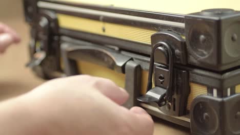 hand opening a case with catch lock mechanism