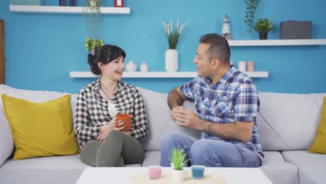 happy couple enjoying coffee at home.