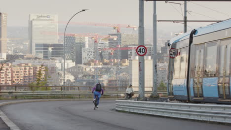 cyclists descend kongsveien by ekebergsparken on a sunny weekday morning