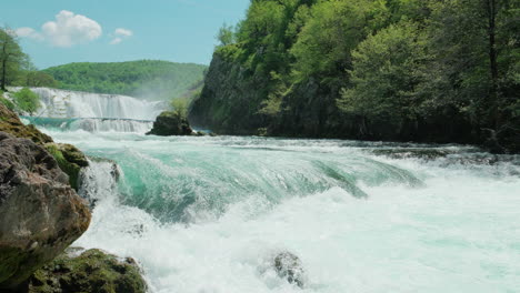 a waterfall of a pure wild river located in a green rainforest