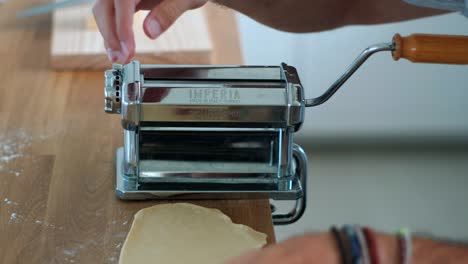 Close-Up-of-Man's-Tagliatelle-Preparation-with-Traditional-Pasta-Machine---4K-Footage