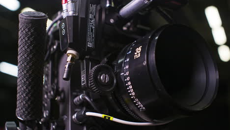 modular professional cinema camera with sensor block separated from the body, high end cinema lens focus ring being turned by a remote focus motor by a focus puller