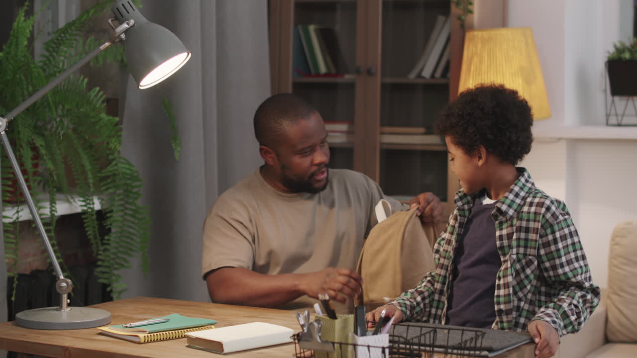 Afro Man Getting Son Ready For School