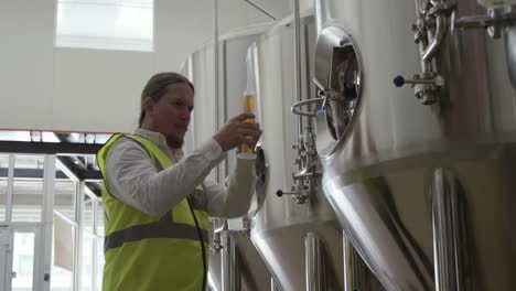 caucasian man working at a microbrewery