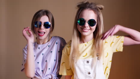 two girls posing in trendy outfits