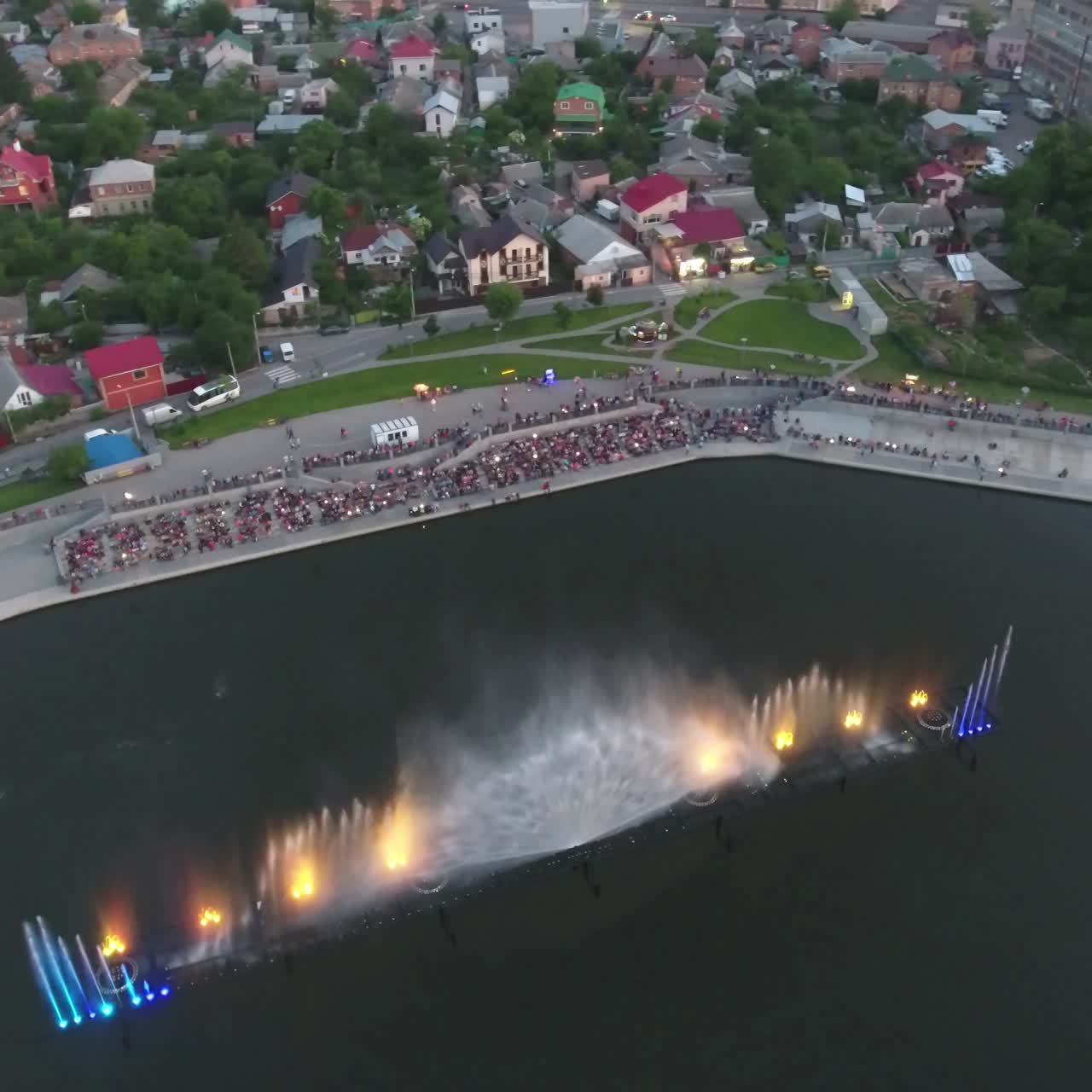 Fountain With Colorful Illuminations At Night. Aerial shot of the magic fountain - lights,colors and music spectacle at night