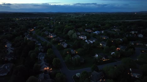 aerial view of a serene american suburban neighborhood at dusk. streetlights cast a warm glow over tree-lined streets and cozy homes with a vast peaceful landscape stretching into the horizon. pa,usa