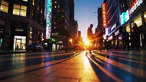 low-angle video shot of a bustling city street at dusk, capturing silhouettes of pedestrians