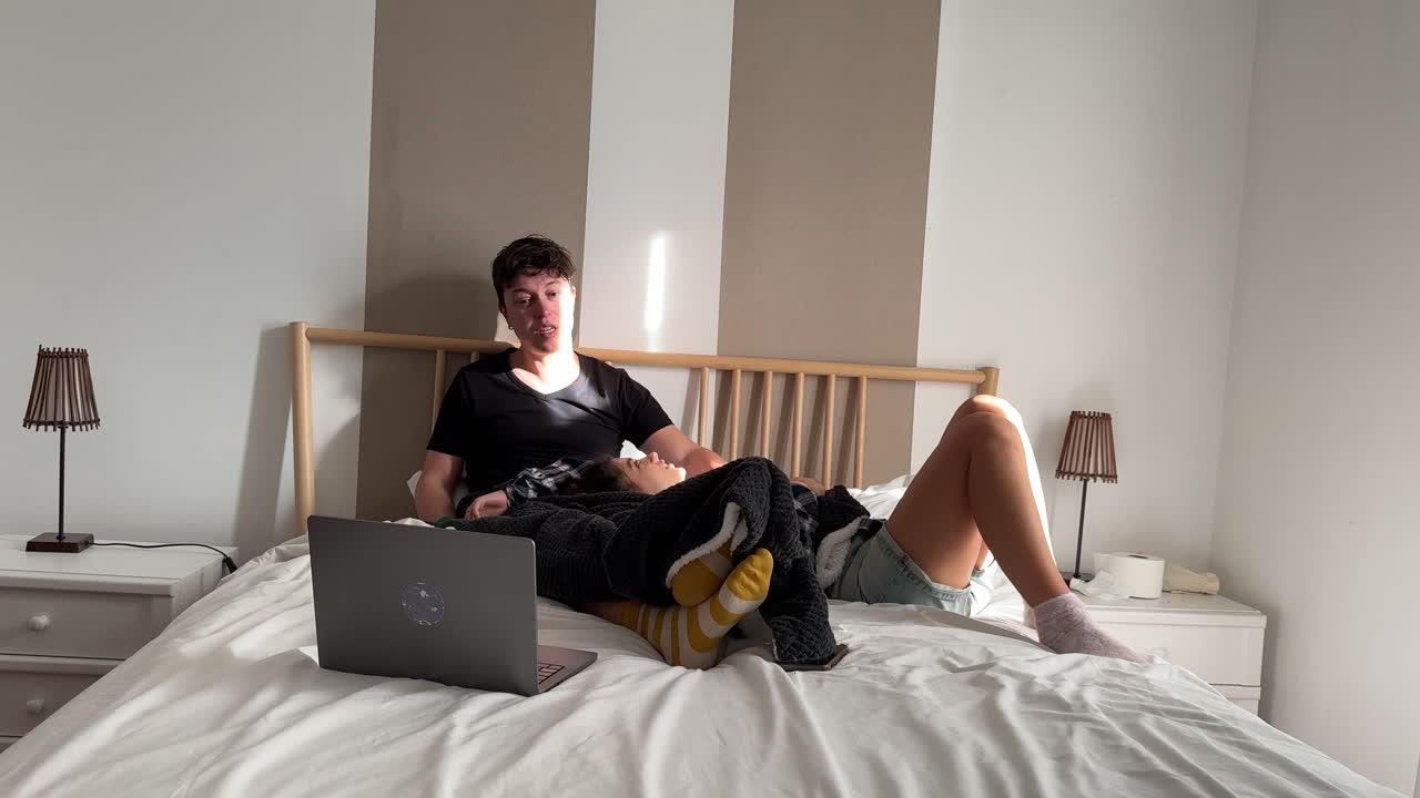 Couple Relaxing on a Bed