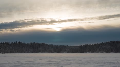 sunset over frozen lake with people walking during winter