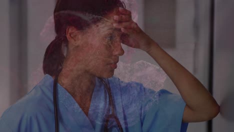 digital waves against stressed female health worker sitting in the corridor at hospital