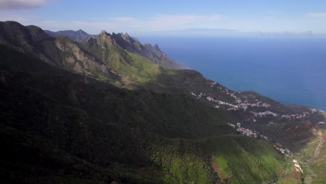 drone flying over beaked volcanic mountains of anaga national park in tenerife, spain