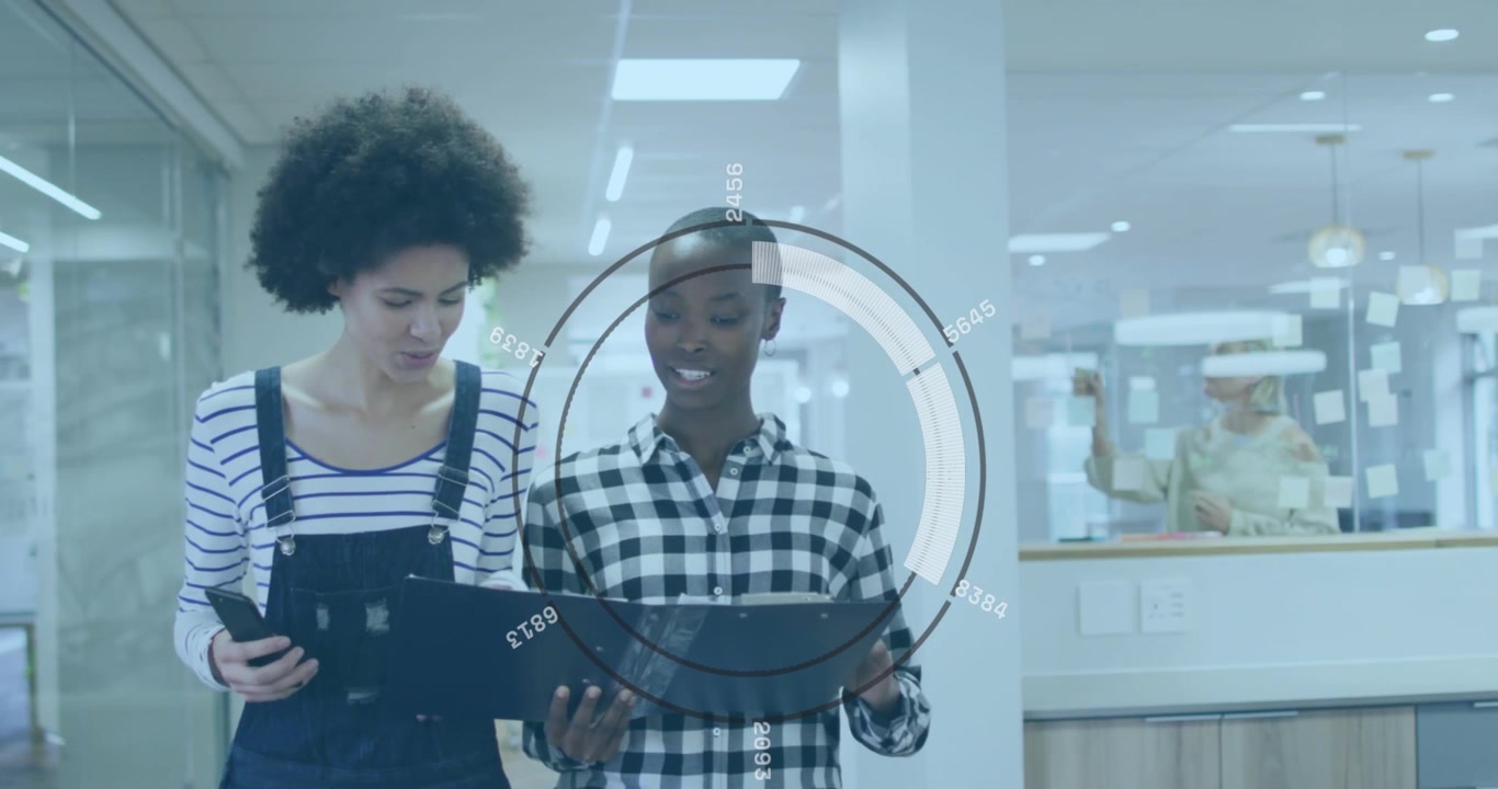 Animation of round scanner over two diverse female colleagues discussing while walking at office