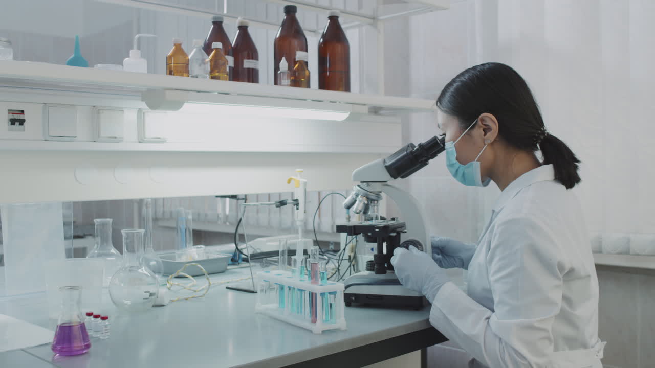 Asian Female Chemist Working in Lab