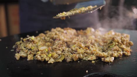 hearty serving of chopped meat and spices cooked in hot stone griller - zoom out