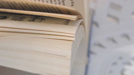 Woman&#039;s hands flipping through a book