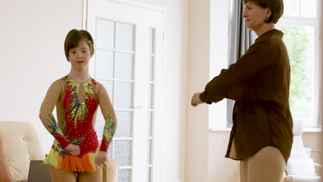 young gymnast rehearsaling at home with her mother