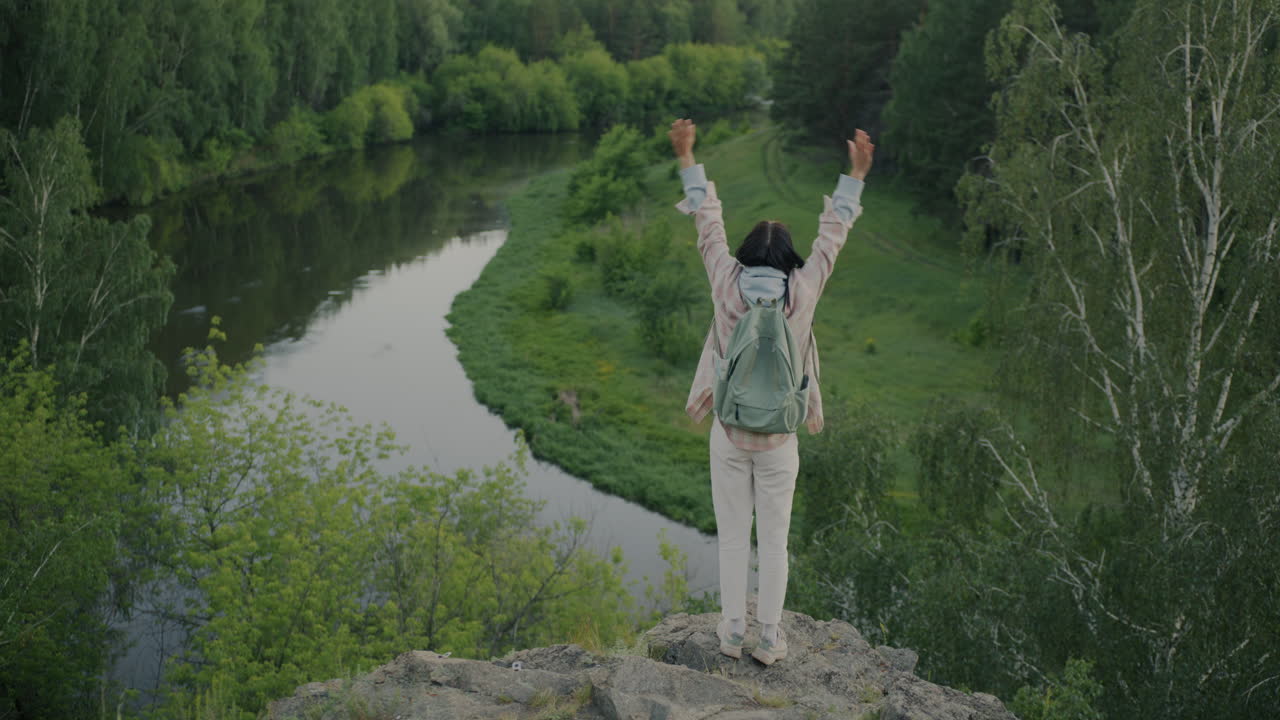 Woman enjoying a scenic view from a mountain top