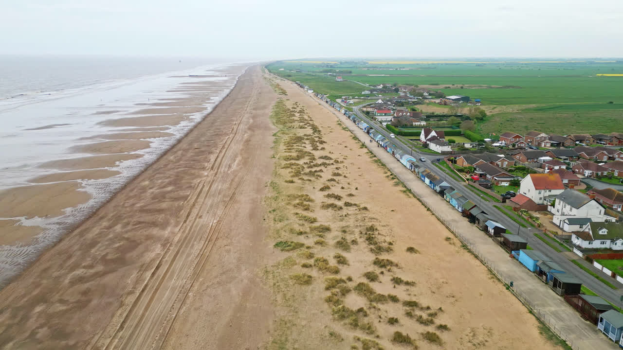 Discover the coastal haven of Mablethorpe through aerial views, spotlighting beach huts, sandy beaches, amusement parks, rides, and the tourist&rsquo;s delight
