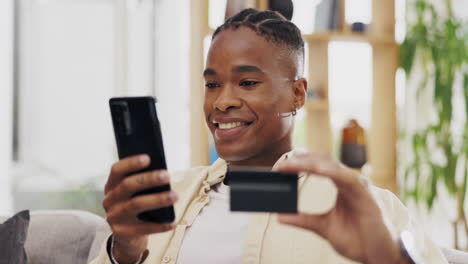 Phone,-credit-card-and-black-man-online-shopping