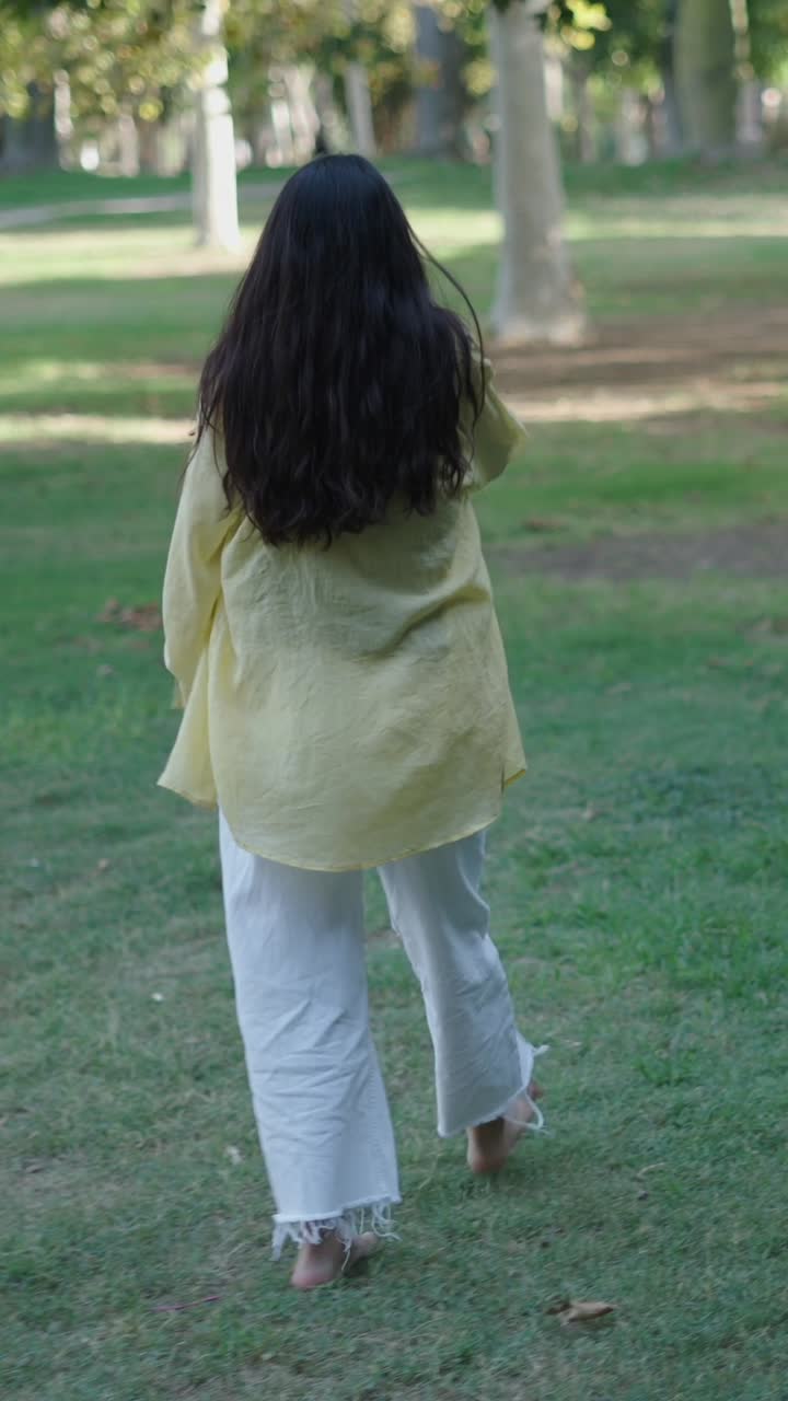 Woman Walking Barefoot in Park