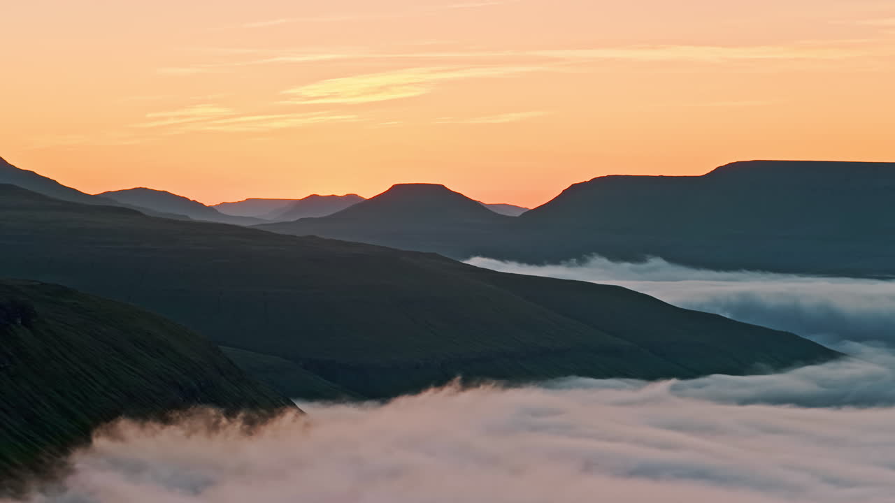 Sunrise or Sunset Over Foggy Mountain Valleys
