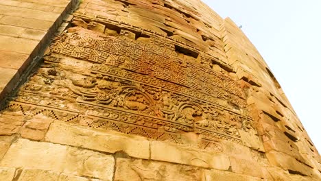 the floral carvings on the side of the ancient dhamek stupa in sarnath, varanasi, india with close up shot