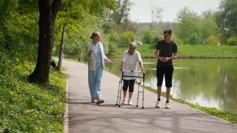 elderly woman receiving assistance while walking in park