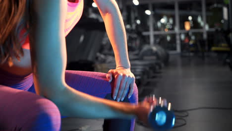 beautiful fitness woman with lifting dumbbells. sporty girl showing her well trained body. gym and fitness
