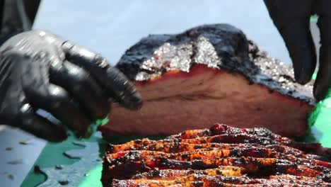 Slicing-off-and-neatly-stacking-cuts-of-brisket-for-a-BBQ-cook-off-competition