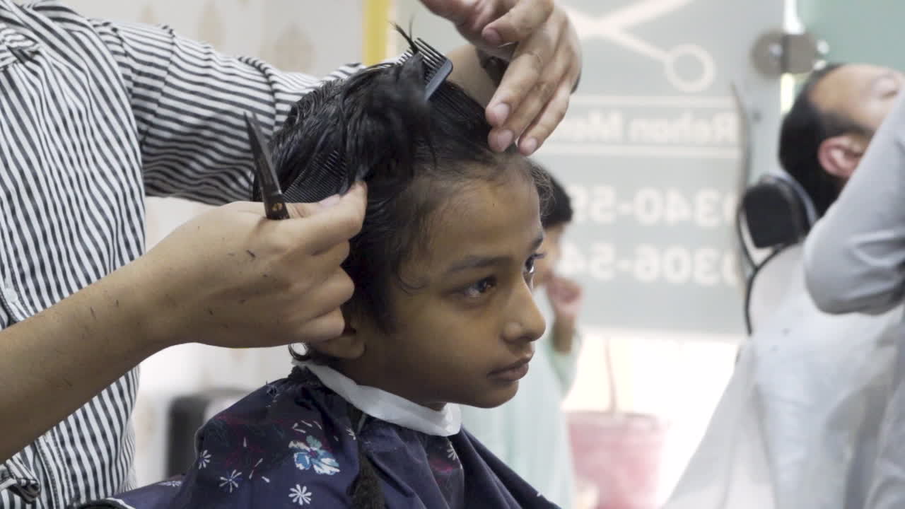 Young Boy Getting a Haircut at a Barbershop