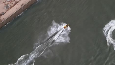 Couple-Of-Tourists-Speeding-On-Waverunners-With-A-View-Of-The-The-Embankment