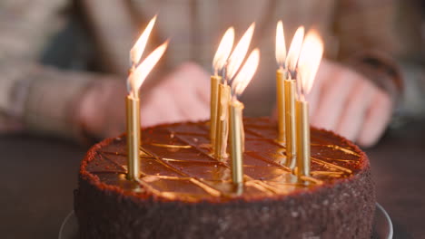 close up of lighted candles on birthday cake