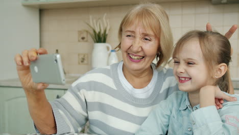 grandmother and granddaughter taking selfie