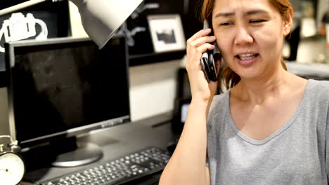 4k asian woman talking via smartphone in office space