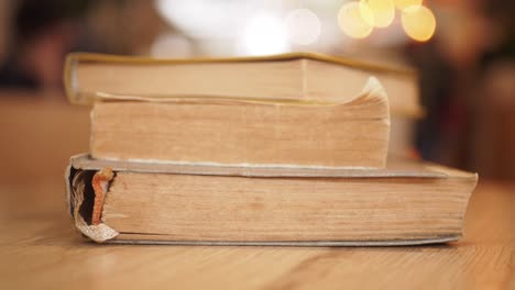 close up of old books on a wooden table