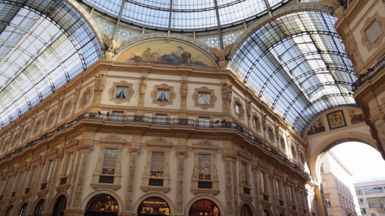 Galleria Vittorio Emanuele II mall inside under the glass dome in Milan, wide shot looking up during daytime