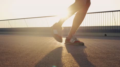 man running on a city rooftop at sunset