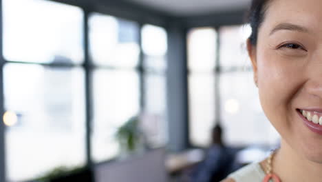 Portrait-of-smiling-asian-businesswoman-in-office,-slow-motion,-copy-space