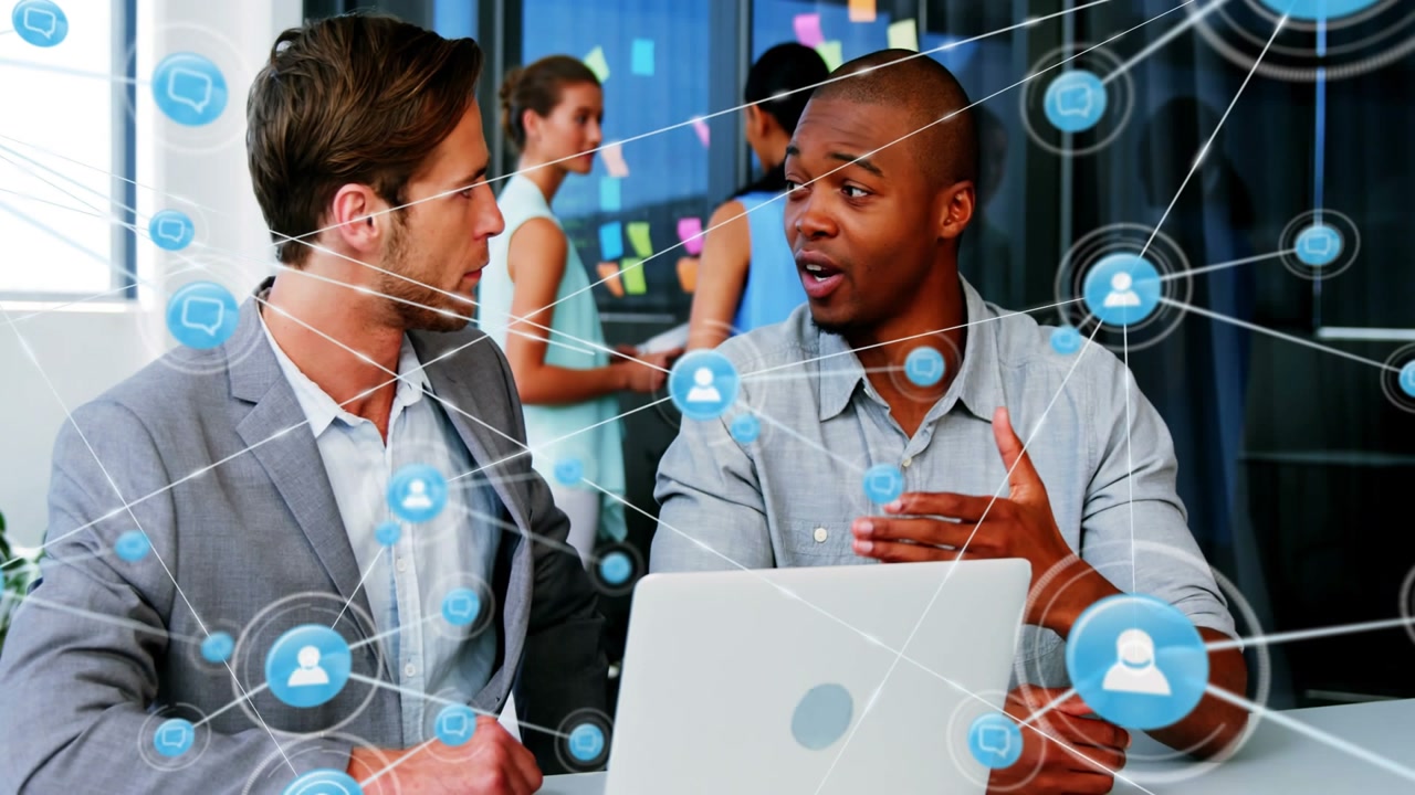Seated pair leaning toward laptop screen lighting, blue network icons expanding to show team links