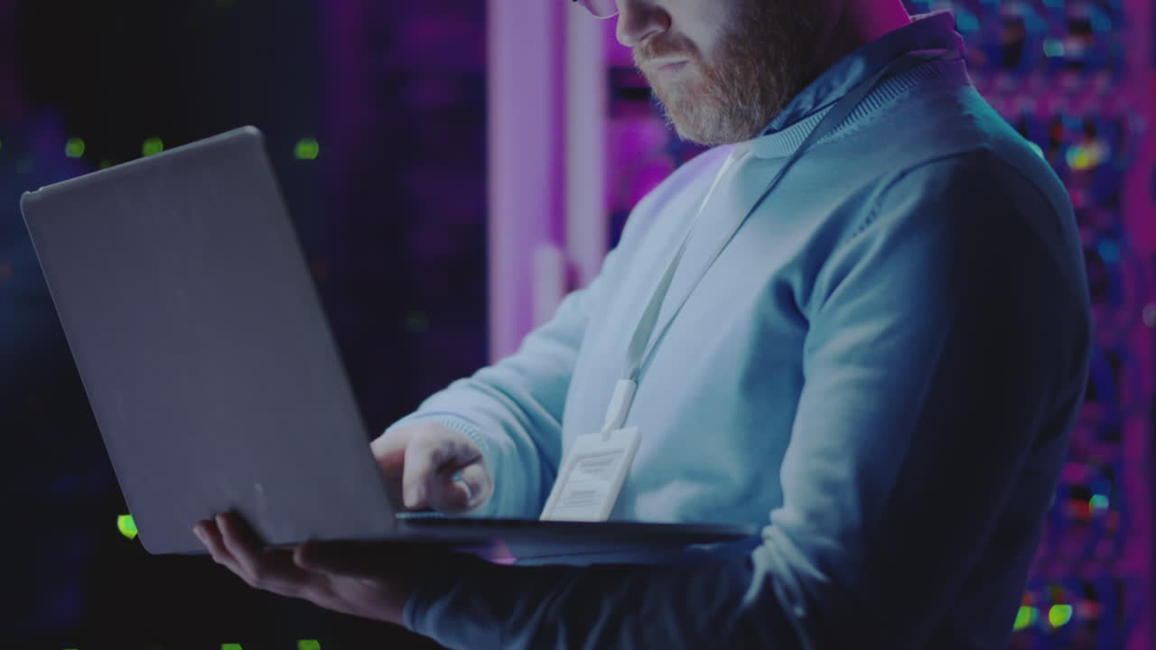 IT Professional Working with Laptop in a Data Center