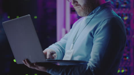 it professional working with laptop in a data center