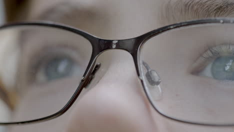 Closeup-on-a-boy-with-pretty-blue-eyes-and-wearing-glasses-as-he-gazes-up-towards-the-sky