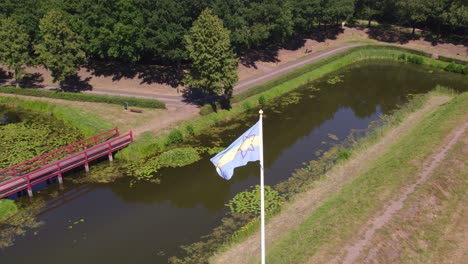 Drone-shot-of-the-flag-of-star-shaped-Fort-Bourtange,-Groningen