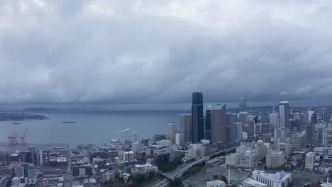 Drone-shot-zooming-out-from-Seattle's-downtown-buildings-on-a-cloudy-day