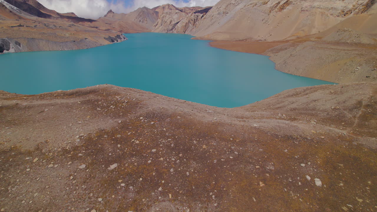 Aerial view of the World's highest altitude Lake Annapurna region, blue lake reflects sky, clouds, hills surround the beauty of natural tourism, grounds hold unity Nepal 4K
